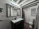 Bathroom features a granite vanity countertop, framed mirror, sink, and modern light fixture at 6166 9Th N Ave, St Petersburg, FL 33710