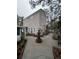 The exterior of this two-story home features a swing, fountain, and landscaped yard at 6166 9Th N Ave, St Petersburg, FL 33710