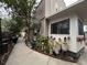 The exterior features a narrow walkway and potted plants alongside the building at 6166 9Th N Ave, St Petersburg, FL 33710