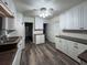 White kitchen with granite countertops, stainless steel sink and a view of the open concept floor plan at 6166 9Th N Ave, St Petersburg, FL 33710