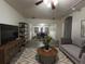 Spacious living room featuring stylish furnishings and wood-look flooring that extends to the adjacent dining area at 6166 9Th N Ave, St Petersburg, FL 33710