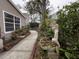 This home features a side yard with mature trees, manicured landscaping and lawn art at 6166 9Th N Ave, St Petersburg, FL 33710