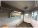This sunroom offers ample natural light, storage shelves, and backyard access at 6166 9Th N Ave, St Petersburg, FL 33710