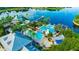 Stunning aerial view of a community with a lake, pool, and luxurious homes with palm trees, promising a resort-style living at 625 Mirabay Blvd, Apollo Beach, FL 33572