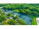 Aerial view of a community featuring multiple tennis courts surrounded by lush greenery, offering an active lifestyle at 625 Mirabay Blvd, Apollo Beach, FL 33572