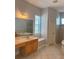 Bathroom with double vanity, soaking tub, shower and window at 625 Mirabay Blvd, Apollo Beach, FL 33572