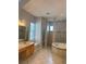 Bathroom with double vanity, soaking tub and tiled glass shower at 625 Mirabay Blvd, Apollo Beach, FL 33572