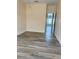 A spacious bedroom with wood-look flooring and a view to another room at 625 Mirabay Blvd, Apollo Beach, FL 33572
