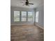 Bright bedroom features three large windows and wood-look tile flooring at 625 Mirabay Blvd, Apollo Beach, FL 33572