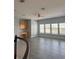Bright bonus room with built-in desk, wood-look floors, a ceiling fan and plenty of natural light from large windows at 625 Mirabay Blvd, Apollo Beach, FL 33572