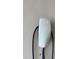 Close up of a white Tesla charger with a green light indicator at 625 Mirabay Blvd, Apollo Beach, FL 33572