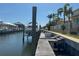 Dock and canal with a boat, complemented by well-manicured landscaping and waterfront living at 625 Mirabay Blvd, Apollo Beach, FL 33572