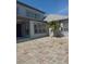 Exterior of home with neutral paint, paved patio, and manicured lawn at 625 Mirabay Blvd, Apollo Beach, FL 33572