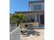 Exterior of home with neutral paint, paved patio, and palm trees at 625 Mirabay Blvd, Apollo Beach, FL 33572