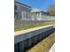 Home's outdoor space featuring a white fence and retaining wall, offering privacy and security at 625 Mirabay Blvd, Apollo Beach, FL 33572