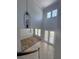 An overhead view of the foyer with staircase, high ceilings, and elegant chandelier at 625 Mirabay Blvd, Apollo Beach, FL 33572