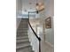 Bright foyer with hardwood stairs, decorative lighting, and an open floor plan at 625 Mirabay Blvd, Apollo Beach, FL 33572