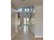 Two-story foyer with tile floors, staircase, and pendant light fixture at 625 Mirabay Blvd, Apollo Beach, FL 33572