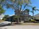 Charming two-story home with a metal roof, a well-manicured lawn, and mature landscaping at 625 Mirabay Blvd, Apollo Beach, FL 33572