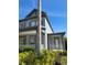 A low-angle view of the front of the house, featuring a porch with white railings and stately columns at 625 Mirabay Blvd, Apollo Beach, FL 33572