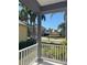 Relaxing front porch showcasing palm trees, neighborhood views, and yellow house at 625 Mirabay Blvd, Apollo Beach, FL 33572