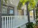 Welcoming front porch showcasing white railings, stately columns, and a glimpse of the neighborhood at 625 Mirabay Blvd, Apollo Beach, FL 33572