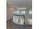 Well-lit upstairs hallway with curved railing, wood-look floors, and archway, leading to other rooms at 625 Mirabay Blvd, Apollo Beach, FL 33572