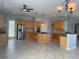 Open kitchen with wood cabinets, granite counters, a gas cooktop, and stainless steel appliances at 625 Mirabay Blvd, Apollo Beach, FL 33572