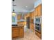 Well-equipped kitchen with stainless steel appliances, granite countertops, and custom cabinetry at 625 Mirabay Blvd, Apollo Beach, FL 33572