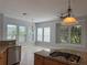 Open kitchen with island gas cooktop, granite counters, and stainless steel dishwasher at 625 Mirabay Blvd, Apollo Beach, FL 33572