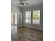 Bright living room featuring wood-look floors, two windows, and french doors at 625 Mirabay Blvd, Apollo Beach, FL 33572