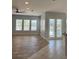 Bright living room featuring wood-look floors, many windows, and sliding glass doors at 625 Mirabay Blvd, Apollo Beach, FL 33572