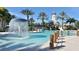 Inviting community pool with a water fountain, featuring a lighthouse-themed water slide and palm trees for a relaxing environment at 625 Mirabay Blvd, Apollo Beach, FL 33572