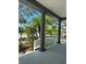 Charming porch offers a view of the landscaped neighborhood and mature trees at 625 Mirabay Blvd, Apollo Beach, FL 33572