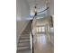 Elegant curved staircase leading to the upper level, with wood-look flooring at 625 Mirabay Blvd, Apollo Beach, FL 33572