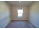 Cozy bedroom featuring neutral carpet, paint, and a sunlit window with pleasant outdoor views at 6422 Towhlen Rd, North Port, FL 34291