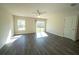 A bright bedroom features vinyl plank flooring, a ceiling fan, and a sliding glass door at 6422 Towhlen Rd, North Port, FL 34291
