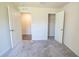 Bedroom showcasing neutral carpet, and a closet and ensuite bathroom through open doors at 6422 Towhlen Rd, North Port, FL 34291