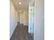 Bright hallway with wood-look flooring, recessed lighting, and multiple doors for easy access at 6422 Towhlen Rd, North Port, FL 34291