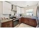 A kitchen with stainless steel appliances, granite counters, tile backsplash, and wood cabinets at 7210 N Manhattan Ave # 1721, Tampa, FL 33614