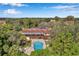 Stunning aerial view of home with private pool, lush greenery, and a serene outdoor living space at 7741 Forest Trl # 7, Port Richey, FL 34668