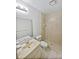 A full bathroom with tile shower, standard toilet, and a large vanity with a mirror at 7741 Forest Trl # 7, Port Richey, FL 34668