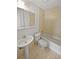 Standard bathroom with a pedestal sink, mirrored medicine cabinet and a tiled shower-tub combo at 7741 Forest Trl # 7, Port Richey, FL 34668
