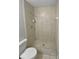 A standard tile shower with shower head, faucet, seat, and soap and shampoo holder at 7741 Forest Trl # 7, Port Richey, FL 34668