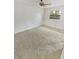 An empty bedroom with neutral carpet and a window allowing natural light at 7741 Forest Trl # 7, Port Richey, FL 34668