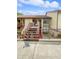 Exterior shot of a two-story building with wood stairs, tile roof and desert landscaping at 7741 Forest Trl # 7, Port Richey, FL 34668
