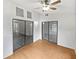 Open living room featuring wood floors, ceiling fan, and sliding glass doors at 7741 Forest Trl # 7, Port Richey, FL 34668