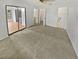 A main bedroom with closet doors, sliders to the lanai, neutral carpet and an ensuite bathroom at 7741 Forest Trl # 7, Port Richey, FL 34668