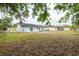 Large backyard showing the home's rear exterior and surrounding landscape at 7934 Aden Loop, New Port Richey, FL 34655