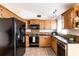 Well-equipped kitchen with ample cabinet space, granite countertops and modern appliances at 7934 Aden Loop, New Port Richey, FL 34655